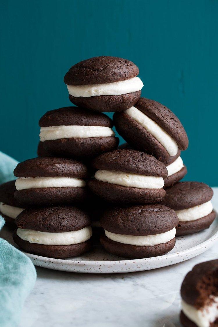 Close-up of chocolate whoopie pies with a thick layer of cream cheese frosting, emphasizing their decadent and inviting look